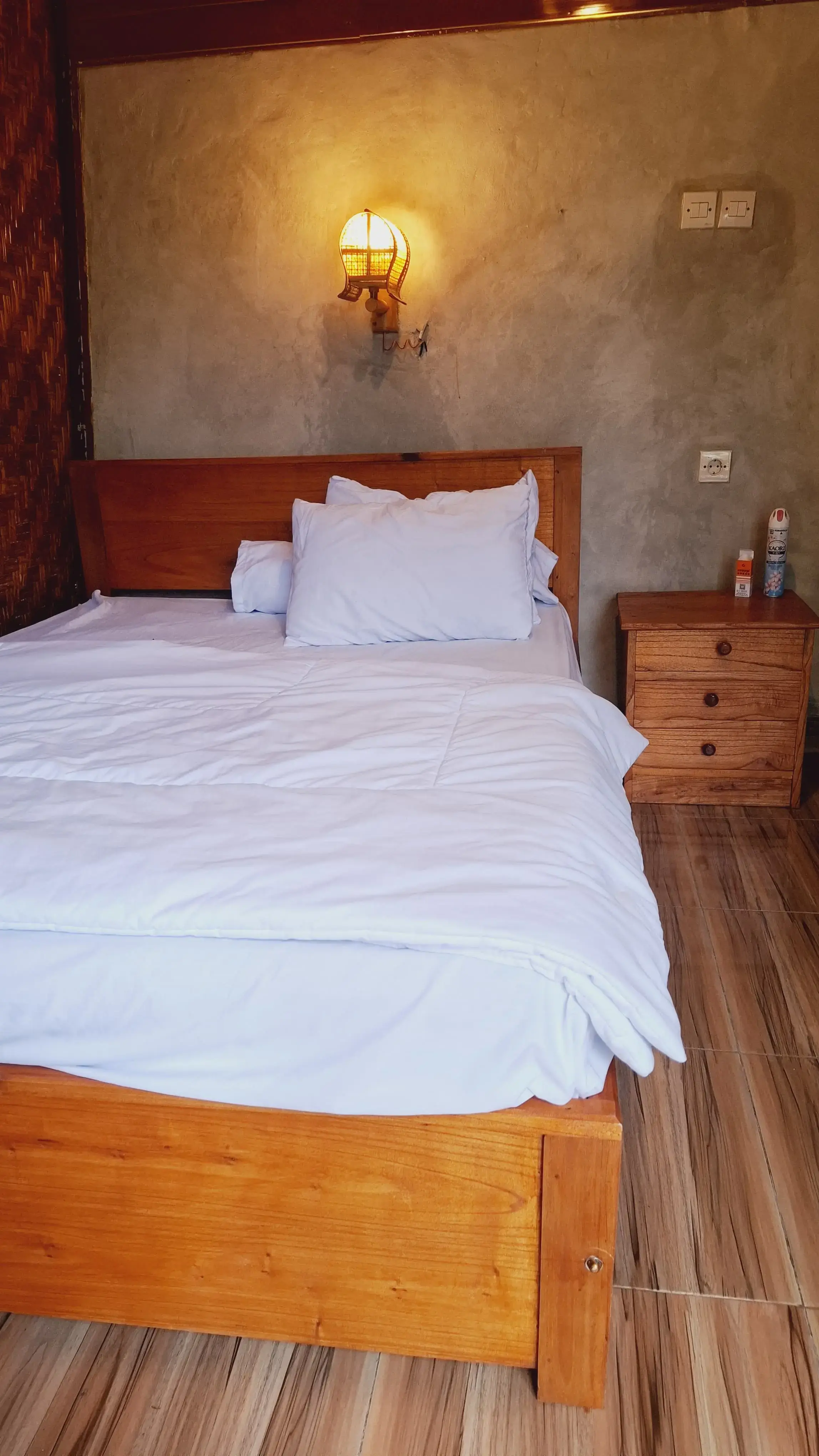 Bamboo homestay room with white linen and local craft decor
